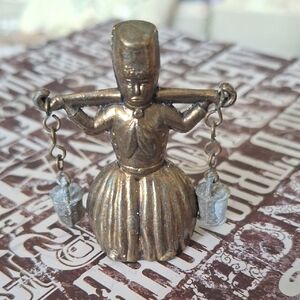 British,Dutch  Bell Milk Maid carrying pails of milk.